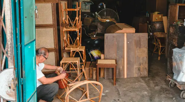 A man repairing a rattan chair
