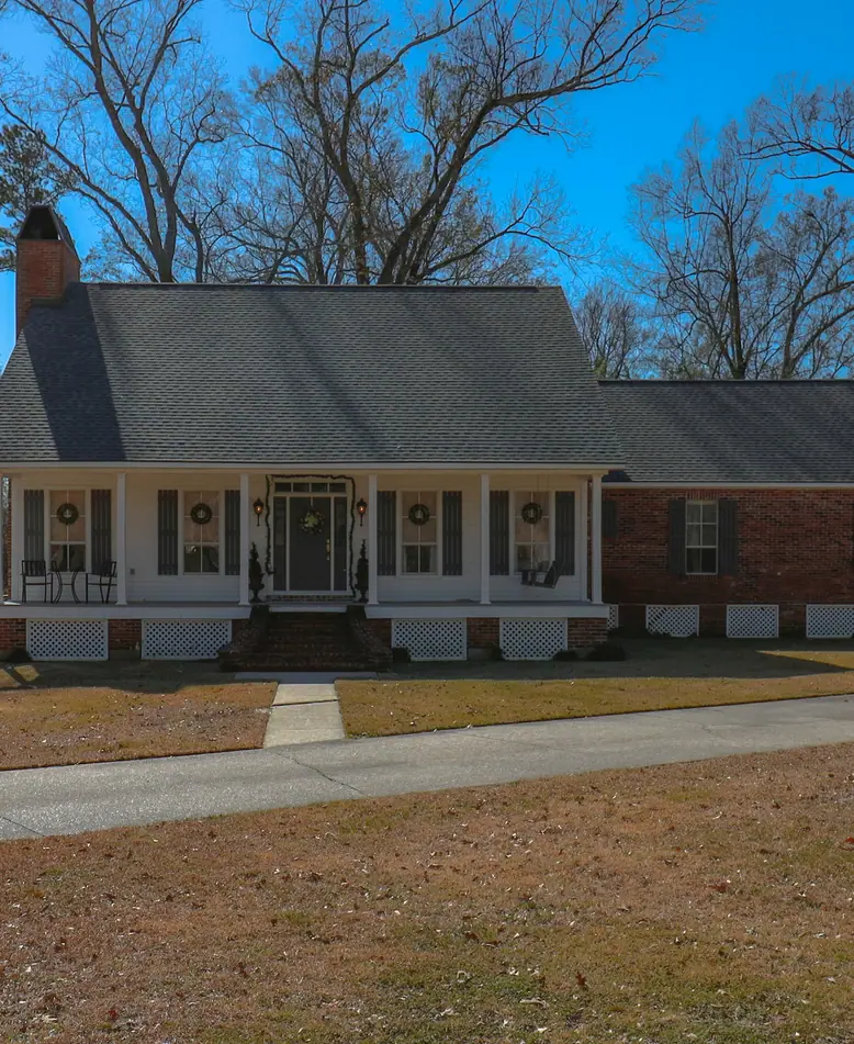 A brick home with a wide front porch in Baton Rouge