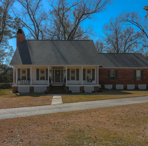 A brick home with a front porch